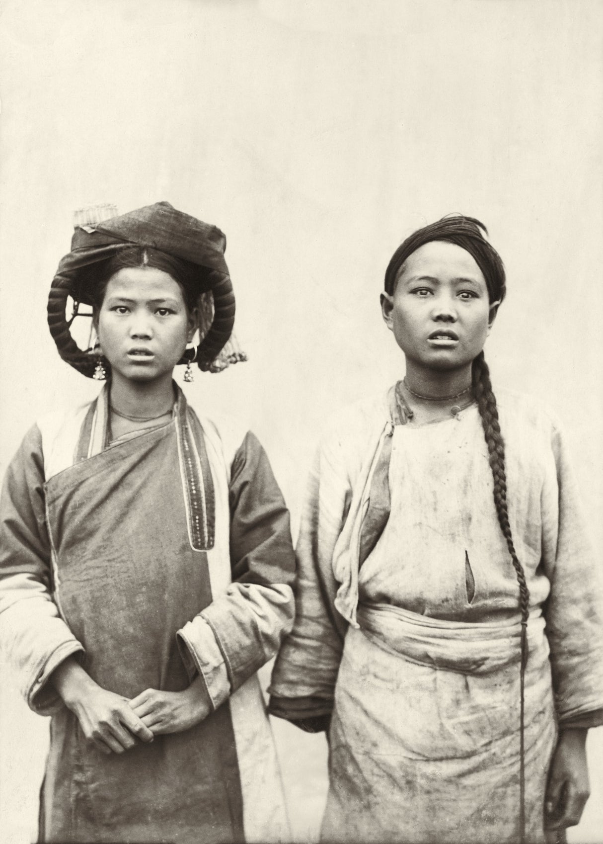 Early 1900s portrait of two young women in traditional highland dress, Northern Indochina