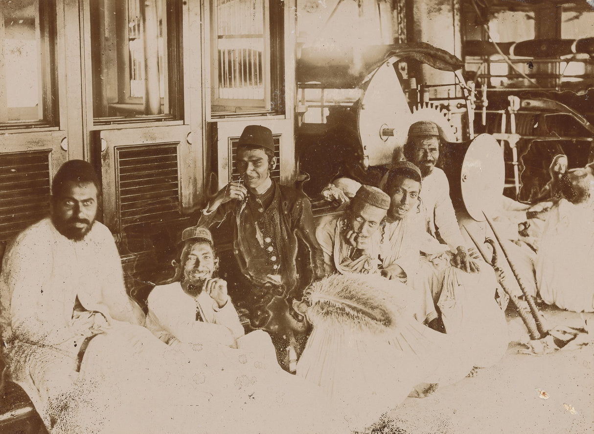 Group of Jewish men in traditional robes resting indoors in Yemen, early 20th century