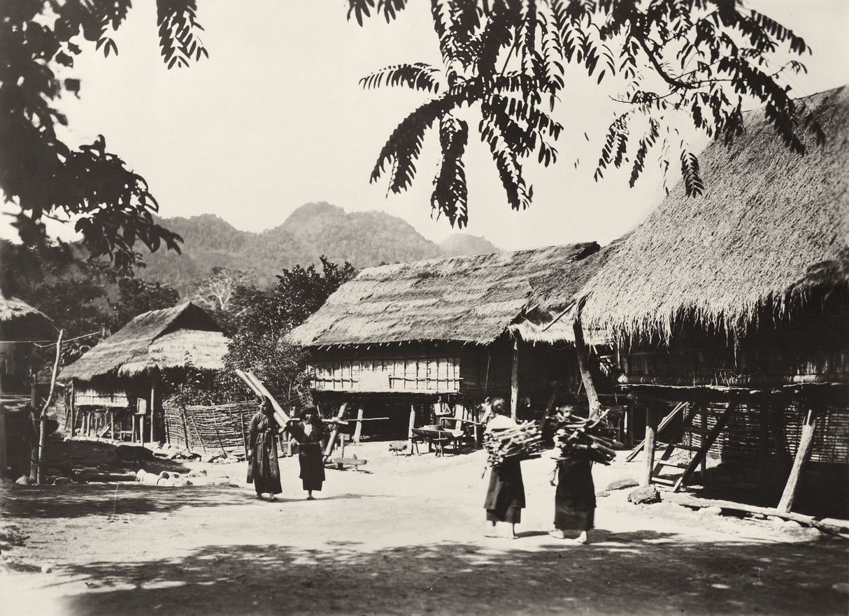 Rural village with thatched houses and villagers carrying firewood, Indochina, 1930s