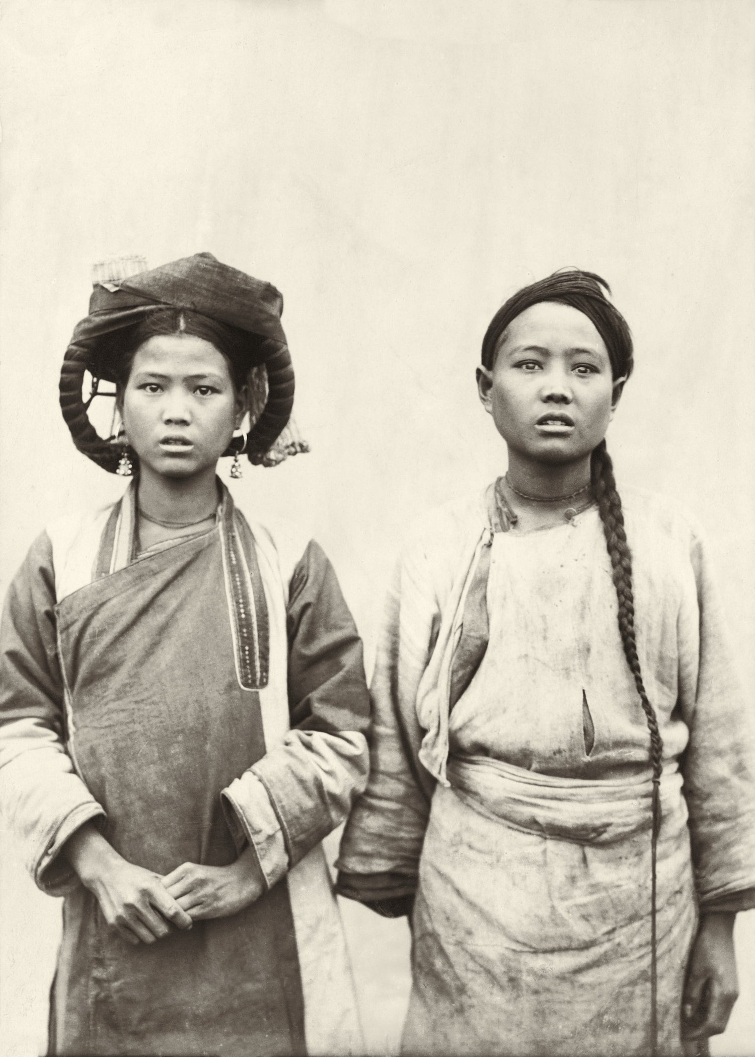 Early 1900s portrait of two young women in traditional highland dress, Northern Indochina