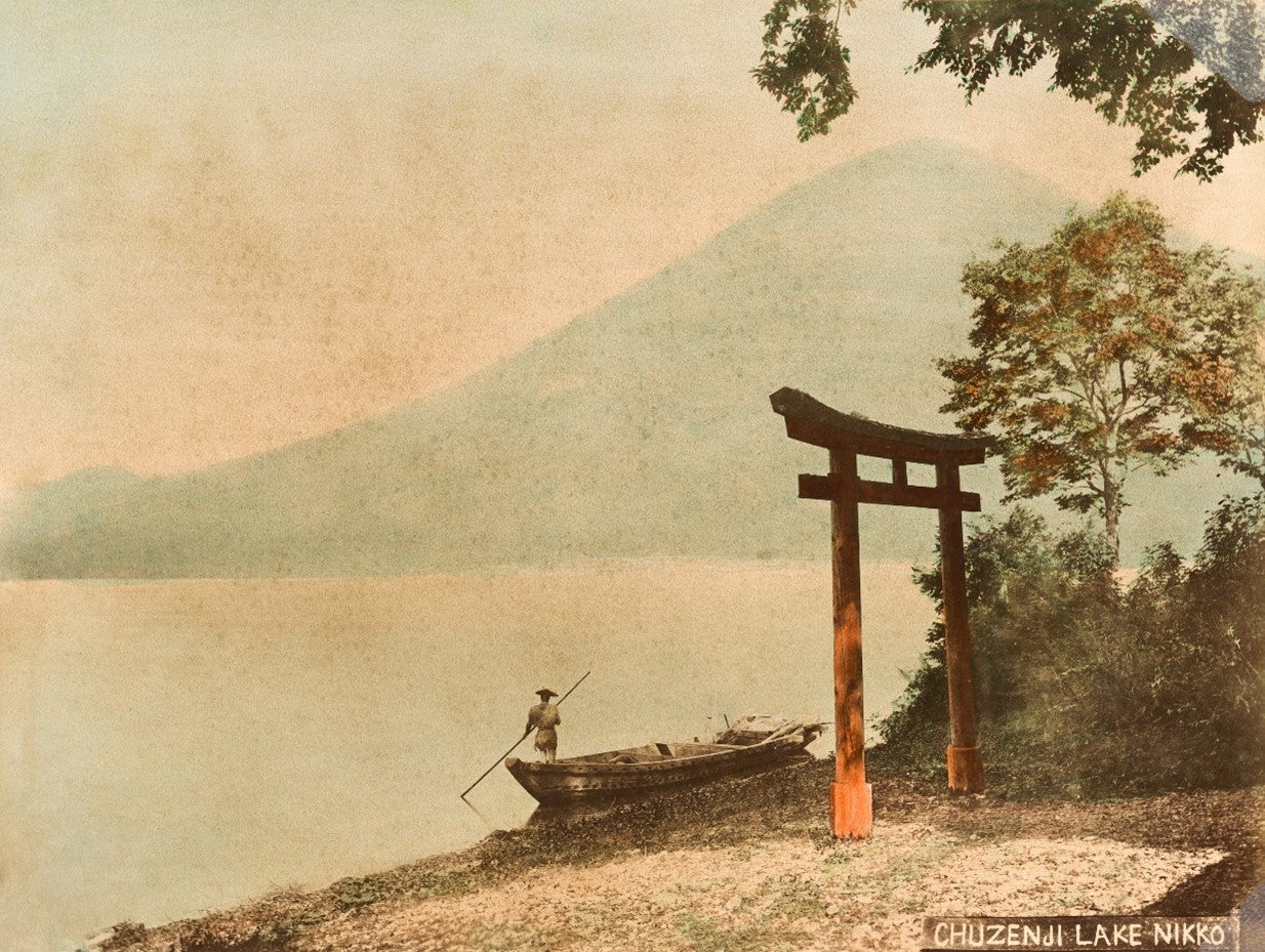 Hand-colored photograph of torii gate by Lake Chuzenji with Mount Nantaisan in background, Meiji-era Japan