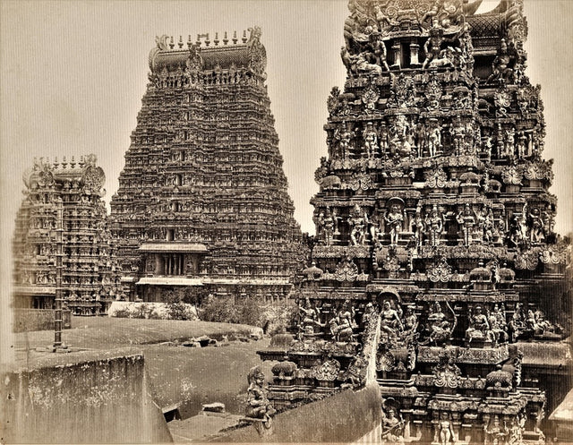 Sepia-toned 19th-century photograph of the Meenakshi Amman Temple in Madurai, featuring intricately carved Dravidian gopurams (gateway towers)