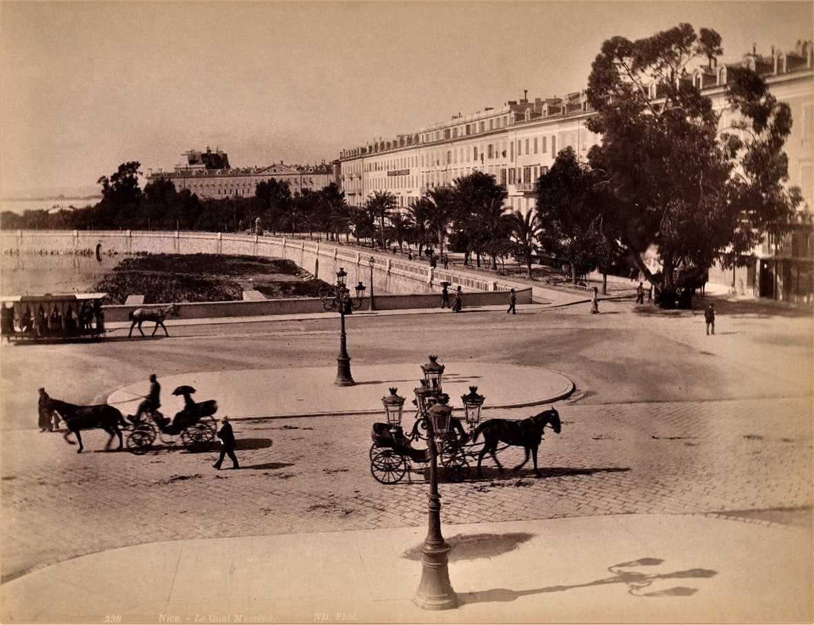 Sepia photograph of Place Masséna in Nice with horse-drawn carriages, circa 1900

