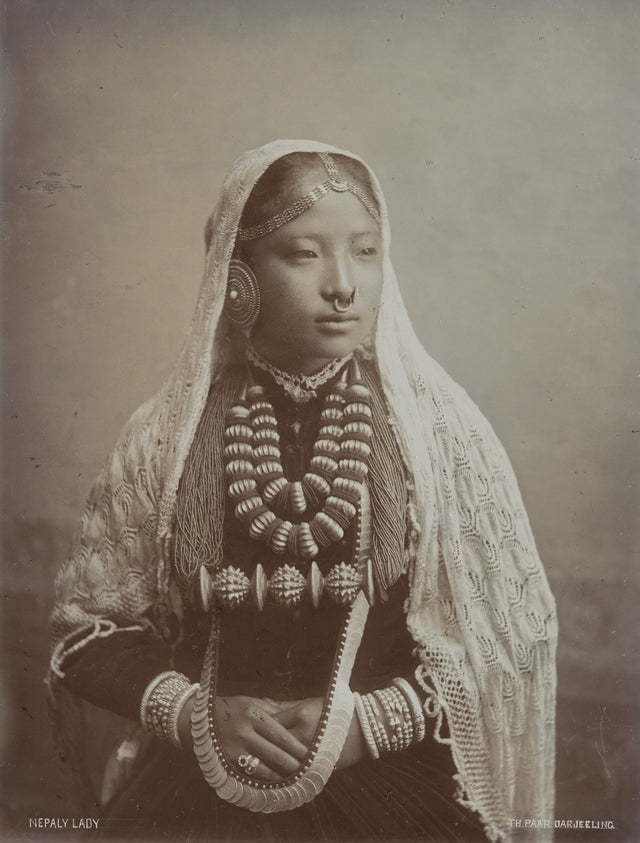 Sepia-toned 1890s studio portrait of a Nepali woman in traditional dress and jewelry, taken in Darjeeling