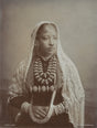 Sepia-toned 1890s studio portrait of a Nepali woman in traditional dress and jewelry, taken in Darjeeling