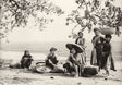 Sepia-toned photo of Vietnamese women vendors resting on a country road under trees, Tonkin, 1930s