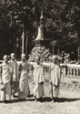 Sepia photo of five young Theravāda monks standing in robes near a forest stupa, Southeast Asia