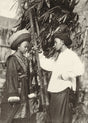 Ethnographic portrait of a young couple in traditional dress near bamboo, Yunnan–Indochina borderlands