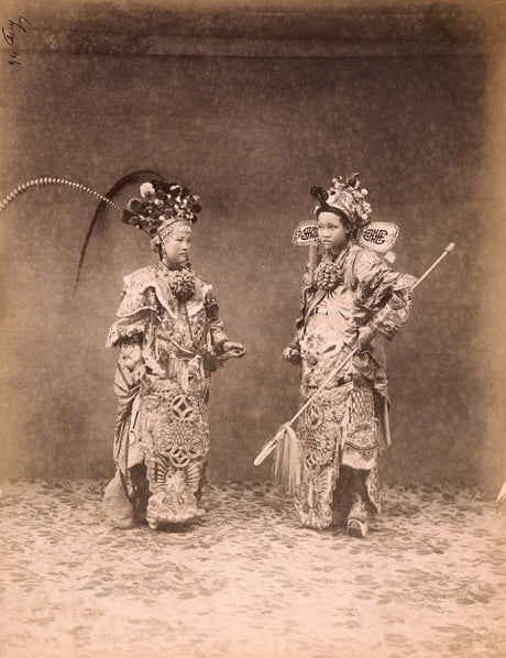 Historic sepia photograph of two Qing dynasty opera performers in elaborate embroidered costumes and ornate headdresses, staged in a studio setting.