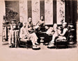 Sepia-toned photograph of Chinese men reclining and smoking in an ornate 19th-century opium den during the Qing Dynasty (1644–1912), surrounded by intricate furniture and decorative screens.