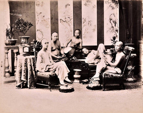 Sepia-toned photograph of Chinese men reclining and smoking in an ornate 19th-century opium den during the Qing Dynasty (1644–1912), surrounded by intricate furniture and decorative screens.