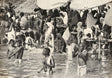 Devotees bathing in the Ganges River during a religious ceremony in Varanasi, late 19th century